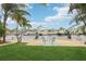 Inviting backyard with manicured lawn, waterfront access, and cozy seating area by the canal at 4942 Blue Heron Dr, New Port Richey, FL 34652