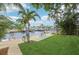 Tranquil backyard overlooking the water, perfect for relaxing with chairs on a lush lawn at 4942 Blue Heron Dr, New Port Richey, FL 34652
