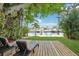 Landscaped backyard with tropical plants and a view of the water at 4942 Blue Heron Dr, New Port Richey, FL 34652