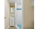 Compact bathroom featuring walk-in shower and vanity with storage at 4942 Blue Heron Dr, New Port Richey, FL 34652