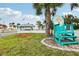 Beach club featuring a turquoise chair with community sign, palm trees and views of the beach at 4942 Blue Heron Dr, New Port Richey, FL 34652