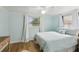 Bright bedroom featuring a ceiling fan, wood floors, and a window for natural light at 4942 Blue Heron Dr, New Port Richey, FL 34652