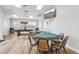 A well-lit billiard room featuring a billiard table, card tables, and a television at 4942 Blue Heron Dr, New Port Richey, FL 34652