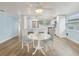 Bright dining area featuring hardwood floors and views into the kitchen and living room at 4942 Blue Heron Dr, New Port Richey, FL 34652