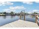 Wooden dock on the canal features a ladder to assist with water access at 4942 Blue Heron Dr, New Port Richey, FL 34652