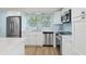 Modern kitchen featuring stainless steel appliances, white cabinetry, and ample counter space at 4942 Blue Heron Dr, New Port Richey, FL 34652