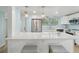 Modern kitchen featuring stainless steel appliances, white cabinetry, and a breakfast bar at 4942 Blue Heron Dr, New Port Richey, FL 34652
