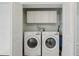 Bright laundry room with white washer and dryer units, and cabinet storage space above at 4942 Blue Heron Dr, New Port Richey, FL 34652