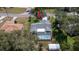Aerial view of property featuring a pool, lush landscaping, a palm tree, and a storage shed at 5309 Bayonne Ave, Spring Hill, FL 34608