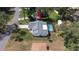 Aerial view of property with screened in pool, gray roof, and backyard shed at 5309 Bayonne Ave, Spring Hill, FL 34608