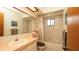 Bathroom with shower and tub combination, large mirror and good lighting at 5309 Bayonne Ave, Spring Hill, FL 34608