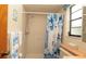 Bathroom with shower, and sink, features floral shower curtain, with small window and decor at 5309 Bayonne Ave, Spring Hill, FL 34608