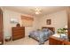 Cozy bedroom features a ceiling fan, vintage radio and soft carpeting for added comfort at 5309 Bayonne Ave, Spring Hill, FL 34608