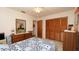 Bedroom with closet and mirror features a ceiling fan and soft carpeting for added comfort at 5309 Bayonne Ave, Spring Hill, FL 34608