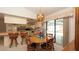 Dining area connecting to the kitchen and lanai, with a round wooden table and barstool seating at 5309 Bayonne Ave, Spring Hill, FL 34608