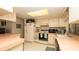 Bright and functional kitchen with ample cabinet space, white appliances, and retro countertops at 5309 Bayonne Ave, Spring Hill, FL 34608
