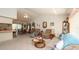 Inviting living room featuring multiple seating options, neutral carpet, and open access to dining area at 5309 Bayonne Ave, Spring Hill, FL 34608
