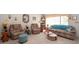 Spacious living room with comfortable seating, neutral carpeting, and abundant natural light at 5309 Bayonne Ave, Spring Hill, FL 34608