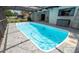 Beautiful backyard pool with screened-in enclosure, patio, and green landscaping at 5309 Bayonne Ave, Spring Hill, FL 34608
