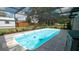 Beautiful backyard pool with screened-in enclosure, patio, and green landscaping at 5309 Bayonne Ave, Spring Hill, FL 34608