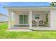 Inviting back porch with tile floor, seating area, and sliding glass door for easy access to the yard at 5328 Baldock Ave, Spring Hill, FL 34608