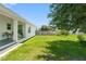Expansive backyard with lush green grass, mature trees, and a privacy fence, perfect for outdoor enjoyment at 5328 Baldock Ave, Spring Hill, FL 34608