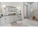 Bathroom featuring a double vanity, granite countertops, modern fixtures, and a separate shower and tub at 5328 Baldock Ave, Spring Hill, FL 34608