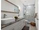 Bright bathroom boasts double sinks with granite countertops, sleek fixtures, and a glass-enclosed shower at 5328 Baldock Ave, Spring Hill, FL 34608