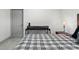 Bedroom features a black desk and a comfortable bed with a grey and white plaid pattern comforter at 5328 Baldock Ave, Spring Hill, FL 34608