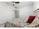 This bedroom is bright with a ceiling fan and a bed with colorful bedding at 5328 Baldock Ave, Spring Hill, FL 34608