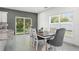 Bright dining area with a large window, neutral paint and adjacent to the kitchen at 5328 Baldock Ave, Spring Hill, FL 34608