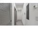 Clean hallway with light walls and neutral flooring, doors and access to storage at 5328 Baldock Ave, Spring Hill, FL 34608