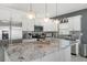 Modern kitchen with granite countertops, stainless steel appliances, and elegant pendant lighting at 5328 Baldock Ave, Spring Hill, FL 34608