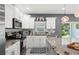 Well-equipped kitchen with white cabinetry, granite countertops, and stainless steel appliances at 5328 Baldock Ave, Spring Hill, FL 34608