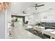 Open-concept living space with modern furnishings, including a gray sofa and stylish lighting fixtures at 5328 Baldock Ave, Spring Hill, FL 34608
