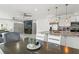 Open-concept living and dining area with hardwood floors, ceiling fans and modern design elements at 5328 Baldock Ave, Spring Hill, FL 34608