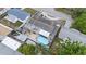 Aerial view showcases a well-maintained home with a private backyard featuring a refreshing pool and patio area at 5330 Dove Dr, New Port Richey, FL 34652