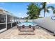 Beautiful backyard features an inviting above ground pool with charming landscaping and screen enclosed patio at 5330 Dove Dr, New Port Richey, FL 34652