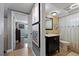 Cozy bathroom next to bedroom with vanity with sink, toilet, and shower with curtain at 5330 Dove Dr, New Port Richey, FL 34652