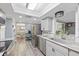 Bright kitchen with modern stainless steel appliances, stone countertops, and a wine refrigerator at 5330 Dove Dr, New Port Richey, FL 34652