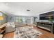 Comfortable living room featuring a large sectional sofa, modern fireplace, and hardwood floors at 5330 Dove Dr, New Port Richey, FL 34652