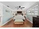 Serene primary bedroom featuring a large bed, hardwood floors, and natural light at 5330 Dove Dr, New Port Richey, FL 34652