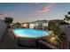 Backyard view of a refreshing pool with an enclosed patio area for outdoor enjoyment and relaxation at 5330 Dove Dr, New Port Richey, FL 34652