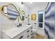 Bright bathroom featuring double vanity, artistic mirror, and luxurious finishes for a modern design at 5340 Pilots Pl, New Port Richey, FL 34652
