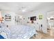 Bright bedroom with travertine floors, ensuite bath, and comfortable furnishings at 5340 Pilots Pl, New Port Richey, FL 34652