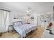 Bright bedroom with travertine floors, ensuite bath, and comfortable furnishings at 5340 Pilots Pl, New Port Richey, FL 34652