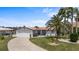 Charming single-story home with mature palms, a two-car garage, and well-maintained landscaping at 5340 Pilots Pl, New Port Richey, FL 34652