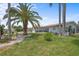 Lush front lawn with a mature palm tree complementing this beautiful home with a two-car garage at 5340 Pilots Pl, New Port Richey, FL 34652