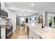 Well-lit kitchen with white cabinets, stainless appliances, and travertine floors at 5340 Pilots Pl, New Port Richey, FL 34652