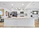 Modern white kitchen featuring an island, stainless steel appliances and tile floors at 5340 Pilots Pl, New Port Richey, FL 34652